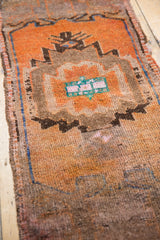 Distressed Oushak rug's playful village weave with even wear, tangerine orange, and earthy brown.