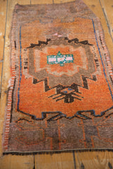 Distressed vintage Oushak runner's fringe and geometric tangerine, coffee, and blue patterns.