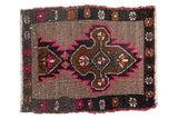 Distressed Oushak rug mat with silver field, brown medallions, hot pink and orange floral border.