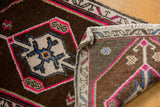 Distressed Oushak rug's hot pink and sky blue pile, revealing its hand-knotted reverse.