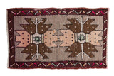 Decorative distressed Oushak rug features oversized double medallions in brown, blush, and ivory.
