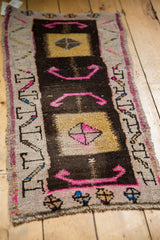 Distressed vintage Oushak rug corner details: hot pink pinwheel, gold squares, running-t border.