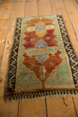 Vintage distressed Turkish Oushak rug, textured pile, warm rust, seafoam green, zigzag border.