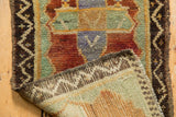 Hand-knotted foundation of vintage Oushak rug revealing distressed texture and geometric border.