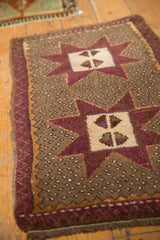 Distressed aubergine starburst medallion and speckled pale coffee brown field of the Oushak rug.