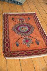 Distressed vintage Oushak rug cartouche border with hot pink details on burnt orange.