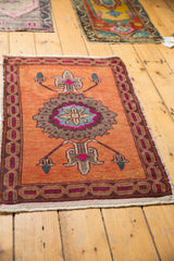 Decorative distressed Oushak rug lower right, burnt orange field, hot pink cartouche border, worn fringe.