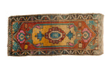 Distressed Oushak runner with gold lozenge medallion, burnt orange, and vivid accents.