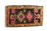 Distressed Oushak rug mat with vibrant pink, saffron, and charcoal geometric patterns, 1'9