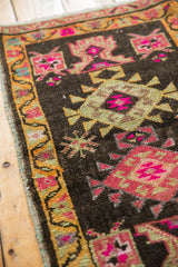 Geometric patterns, saffron vine border, and hot pink accents on a distressed Oushak rug.