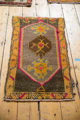 Vintage Oushak rug mat's lower right with hot pink outline and saffron yellow artistic motifs.