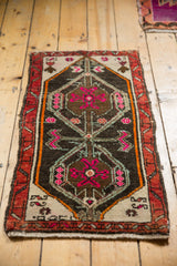 Distressed Oushak mat with softened pile, vibrant hot pink and tangerine accents.