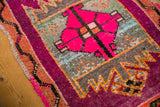 Distressed hot pink medallion, abrashed field, and tangerine border on a vintage Oushak rug.