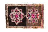 Distressed vintage Oushak rug mat, hot pink double medallions on an abrashed brown field.