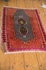 Distressed Oushak rug's rich rust terracotta border, hot pink motifs, original selvage, and even wear.