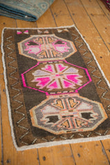 Hot pink gul medallion, distressed pile, and original selvage of the Oushak rug.