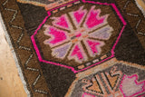 Funky hot pink and dark chocolate geometric pattern on a distressed Oushak rug.