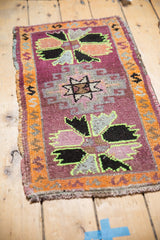 Distressed vintage Oushak rug corner featuring bright mauve, burnt orange border, and highlighter green outlines.