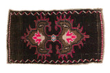 Distressed vintage Oushak mat, dark field, vibrant raspberry, hot pink central floral medallion.