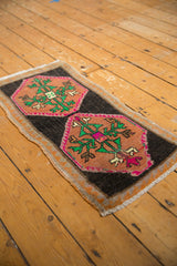 Distressed Oushak runner, soft pile, vibrant pink and green double floral medallions on charcoal.