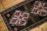 Sharp ivory and hot pink medallion with visible '1985' date on a distressed vintage Oushak rug.