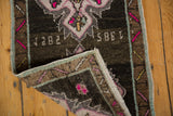 Reverse of Vintage Distressed Oushak rug mat showing '1985' date and light blue selvedge.