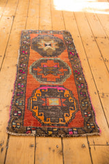 Distressed vintage Oushak runner, low pile texture, abrashed orange field, dark gul motifs.