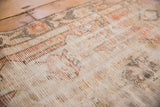 Distressed vintage runner pile texture with faded ivory, charcoal, and cherry red hues.