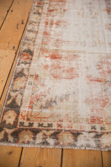 Distressed vintage Oushak runner detail, with faded ivory, charcoal, and cherry red pile.