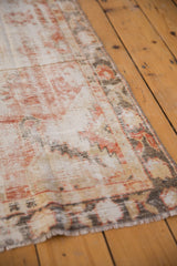 Vintage Distressed Oushak runner's secured side edge, showing faded ivory, red, and charcoal hues.