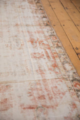 Distressed Oushak runner pile texture with faded ivory and cherry red hues.