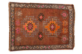 Distressed vintage Oushak rug mat, chestnut brown ground, with double medallions and geometric patterns.