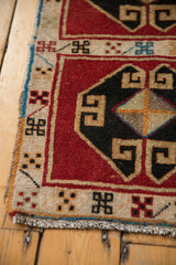 Hand-knotted Oushak rug border featuring geometric motifs in cherry red, black, and ivory.