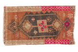 Vintage Distressed Oushak rug mat featuring a geometric medallion in pale rust, charcoal, and fuchsia pink.