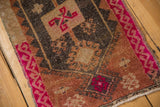 Distressed vintage Oushak rug, fuchsia border, geometric hook and latch patterns.