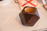 Textured side of the charcoal red geometric wooden planter, showing natural wood interior.