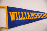 Angled view of the gold felt block letters on the blue Williamsburg pennant.