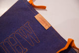 Vintage blue wool felt pennant with orange outline stitching and paper manufacturer tag.