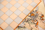 Numbered beige and gray grid bordering an orange-highlighted vintage fortress scene.