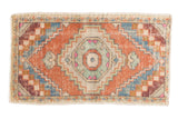 Vintage Distressed Oushak rug with stepped medallion, pale orange, sky blue, and ivory.