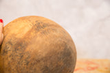 Aged surface of a hand-carved vintage African wooden bowl with varied patina.