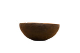 Primitive hand-carved vintage African bowl in dark wood with a rustic, aged patina.