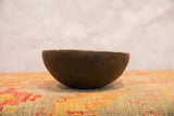 Side profile of the vintage African wooden bowl showing its aged, cracked surface.