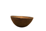 Vintage hand-carved dark brown African wooden bowl with rustic texture.
