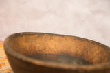 Detail of the hand-carved vintage wooden African bowl's aged, textured interior.