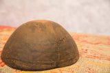 Vintage African bowl detail, showing its visible crack and primitive repair.