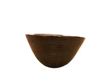 Vintage hand-carved African wooden bowl in dark brown with etched lines and aged imperfections.
