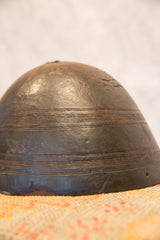 Dark hand-carved vintage African bowl, close-up of side with horizontal lines and aged texture.