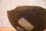Vintage wooden African bowl with distinct light-colored repair on dark wood.