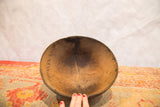 Vintage African bowl's interior, showing hand-carved wood, natural cracks, and aged texture.